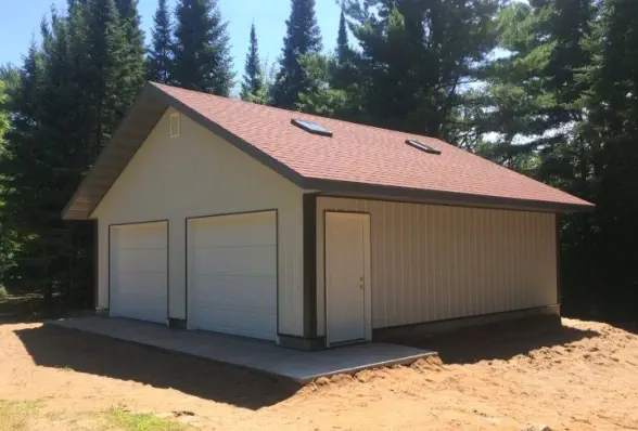 Garage with two large doors and service entrance