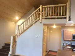 home interior with loft and log railings