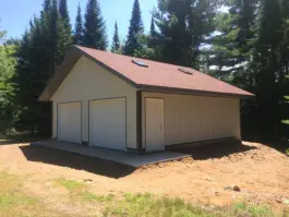 free standing garage on concrete foundation with two garage doors