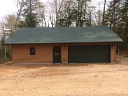 garage with double sized garage door and vinyl siding