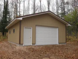 garage with large garage door with steel siding
