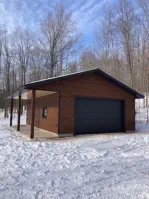garage with two garage doors on concrete foundation and vinyl siding